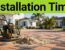 New brick paver patio with construction tools, palms, and a coastal home.