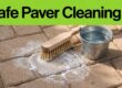 A brush scrubs white residue from brick pavers beside a bucket of water.